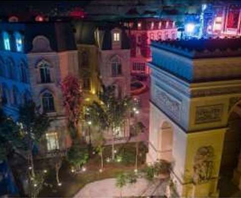 Landscaped courtyard in a European-themed zone at night