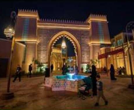 Lit Moroccan gateway with fountain and planting at Boulevard World