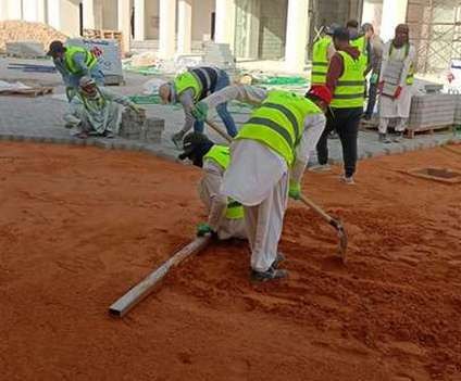Crew installing paving during construction