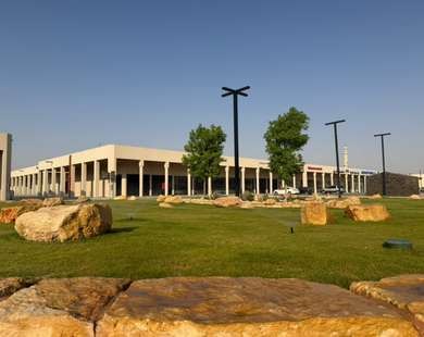 Lawns with trees and boulders along the development