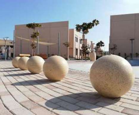 Granite sphere bollards on patterned paving at Nesaj Housing Compound