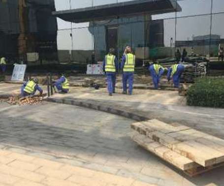 Crew laying paving at the hotel entrance